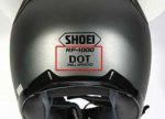 Back of silver motorcycle helmet. DOT certification decal displayed.