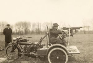 An early Indian Motorcycle Trike, fitted with a rearward facing automatic rifle and seat for a tailgunner.
