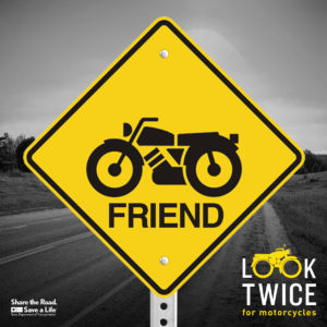 A yellow road sign with a motorcycle and the word Friend. Look twice.
